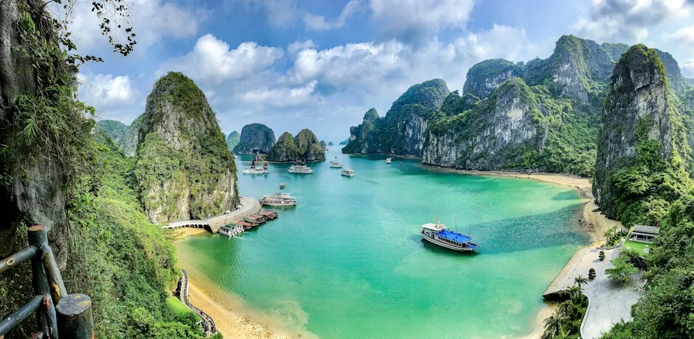 Limestone karst islands and boats in Ha Long Bay Vietnam
